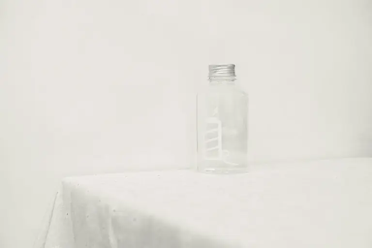 a glass bottle sitting on top of a table