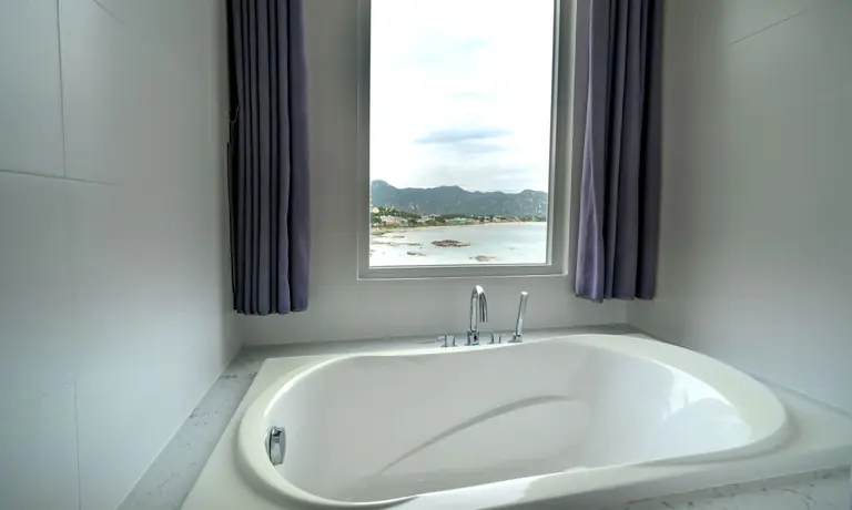 Luxurious bathroom featuring a tub and picturesque mountain view.
