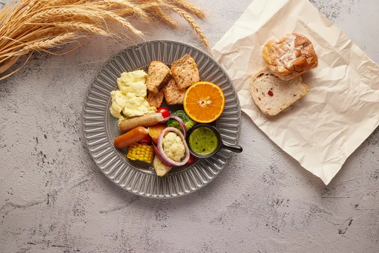 a plate of food on a table next to a napkin