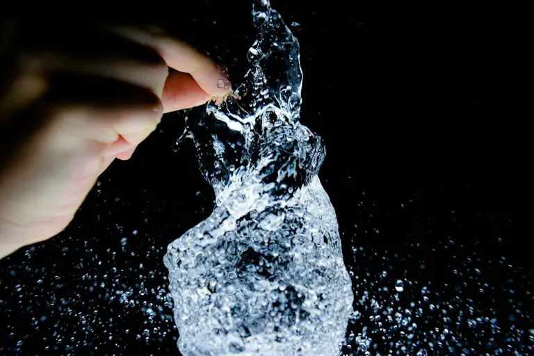 timelapse photography of person holding water in form