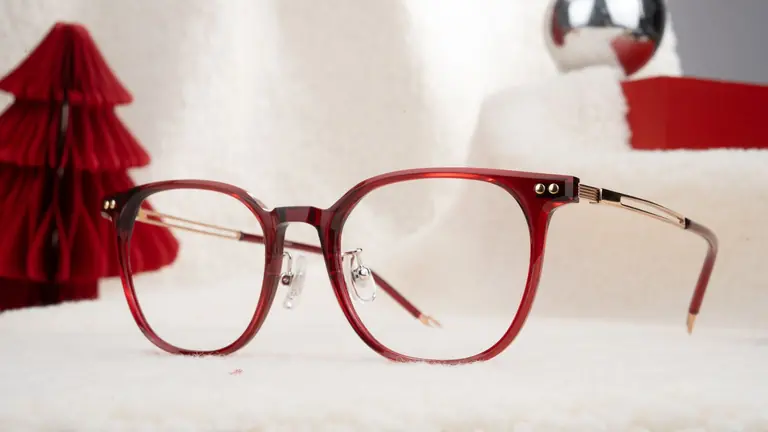 Stylish red glasses with a festive backdrop perfect for holiday fashion and optical promotions.