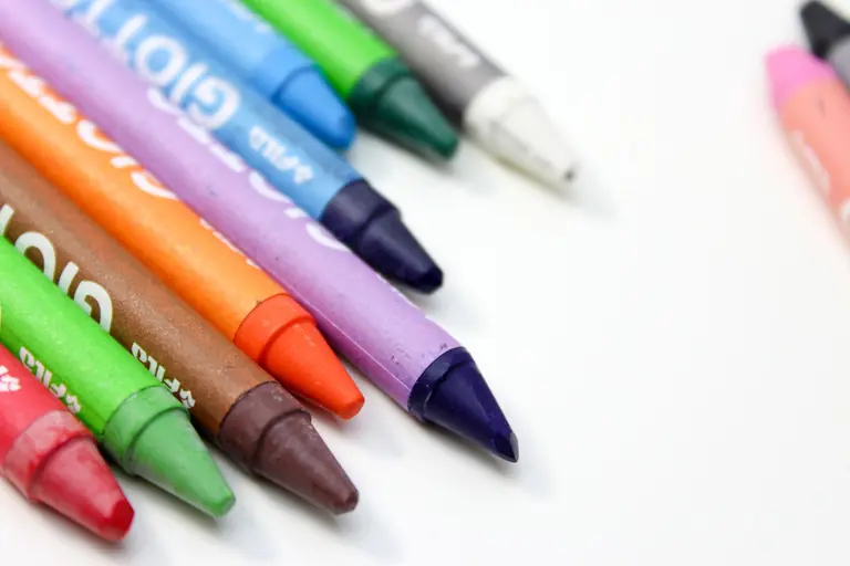 A vibrant close-up of assorted crayons arranged on a white background.