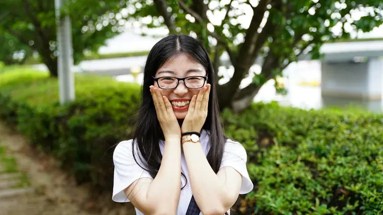 woman in white long sleeve shirt wearing eyeglasses